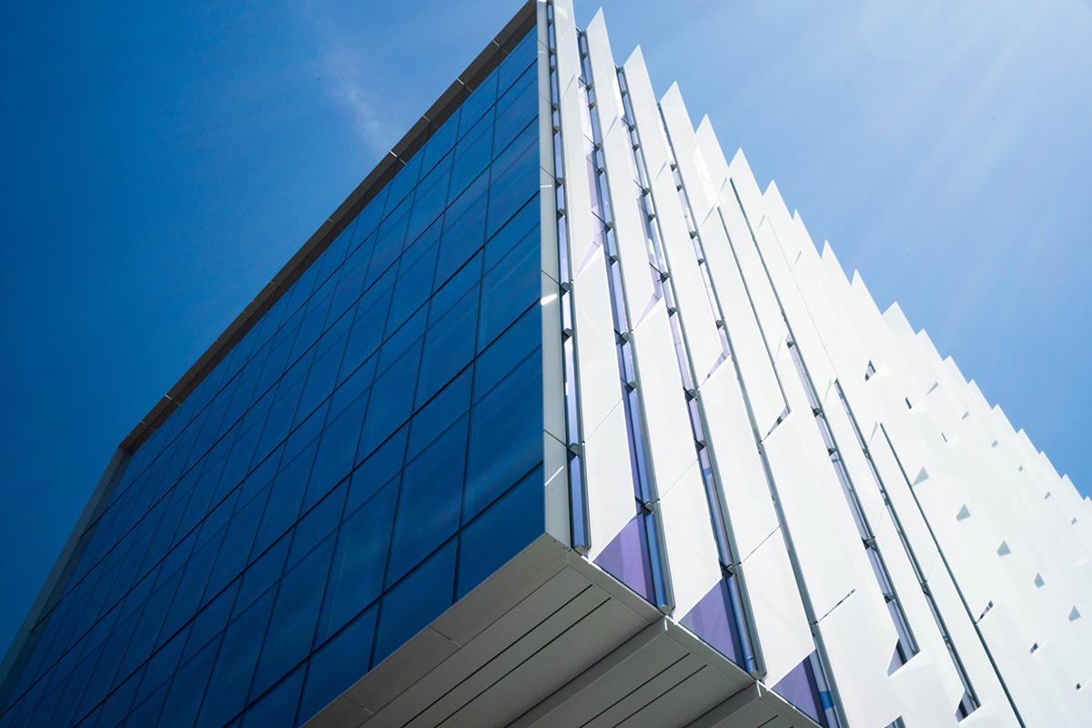 A close-up corner of the façade of the Hans Rosling Center for Population Health on a sunny day