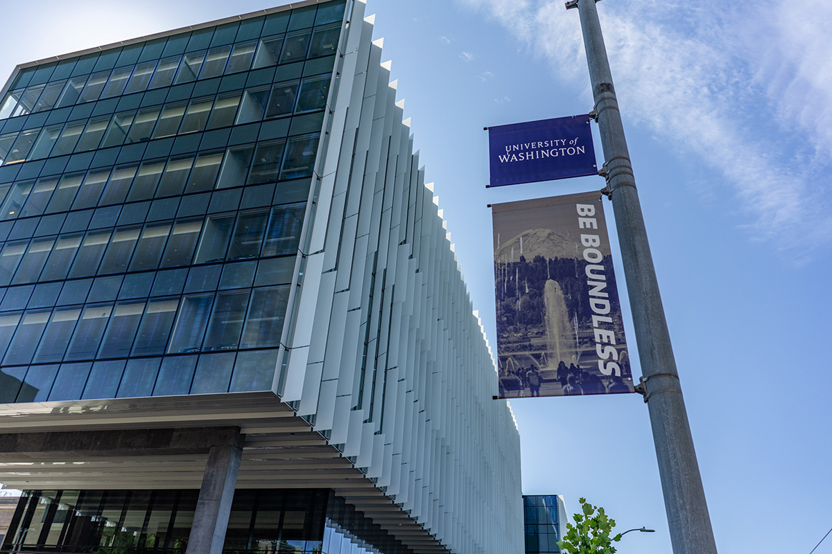 The new Hans Rosling building on a sunny day next to a UW street banner