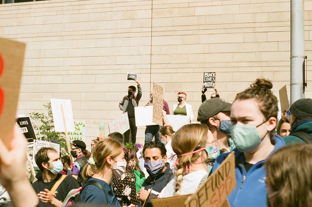 People marching and holding up signs in downtown Seattle