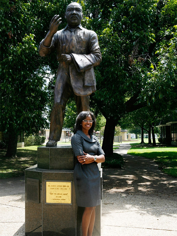 Joyce Tapley standing by MLK statue