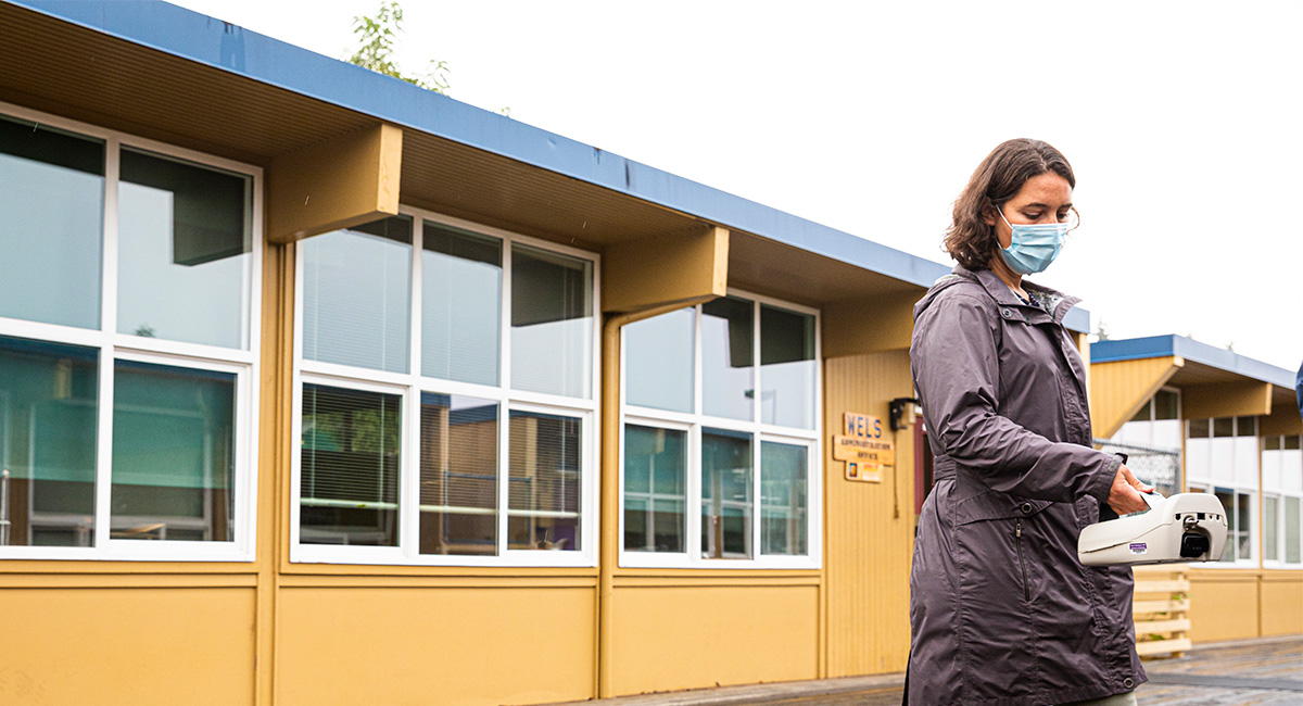 DEOHS Assistant Professor Elena Austin measures air quality outside a school near the Seattle-Tacoma International Airport