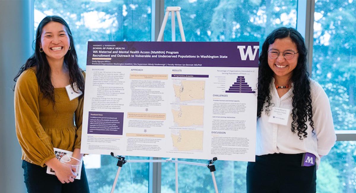 Two students presenting their poster