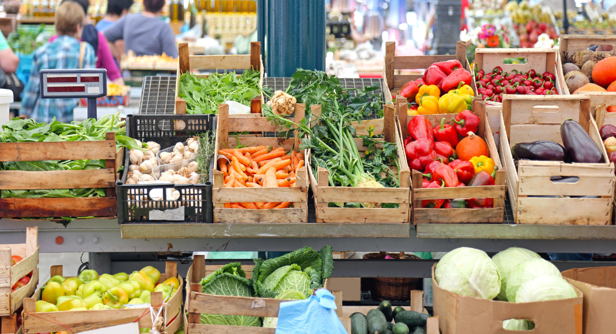 Vegetables sit in a dozen crates at the grocery store