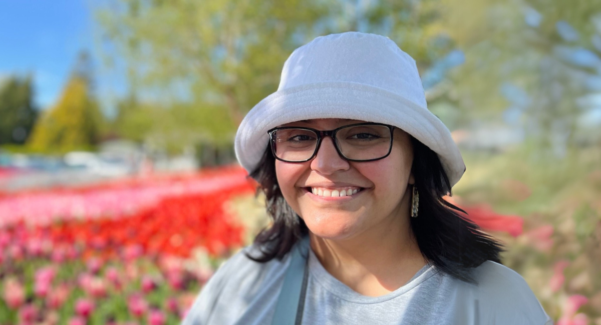 Yilda Macias smiles with pink tulips in the background