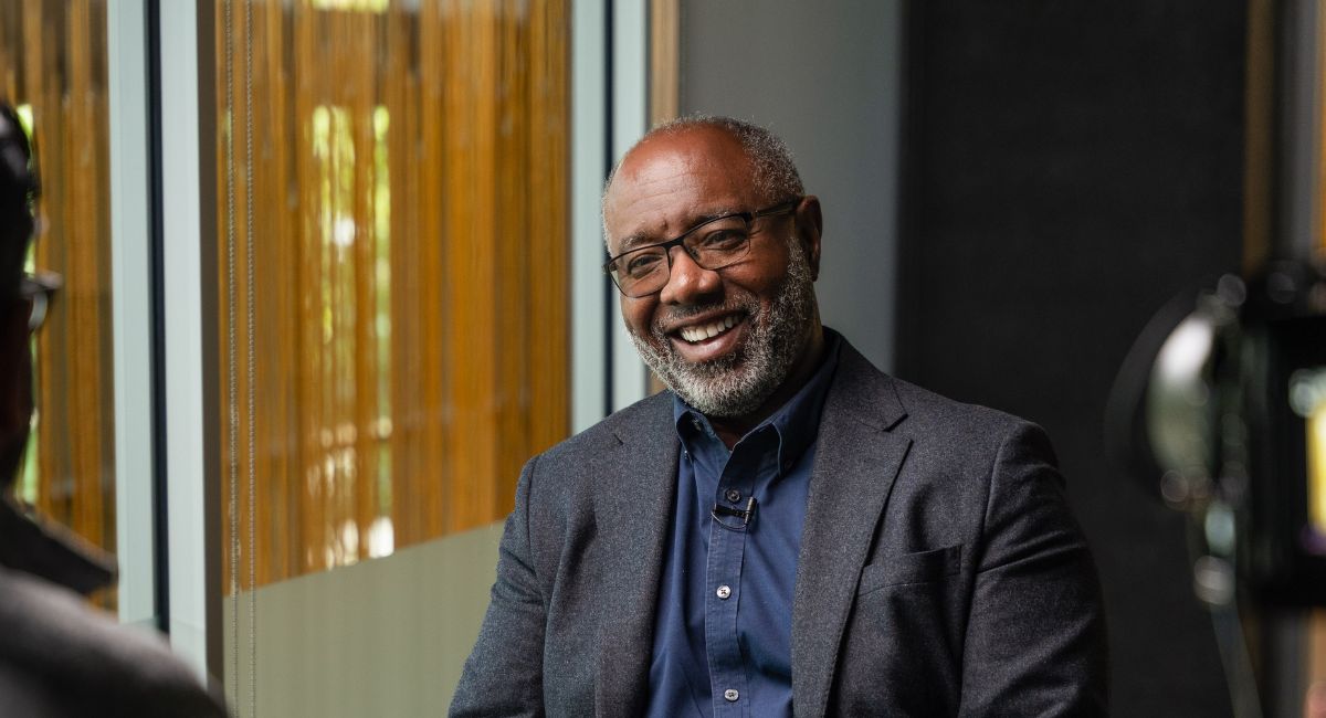 Marvin O'Quinn smiles while talking to off-screen interviewer
