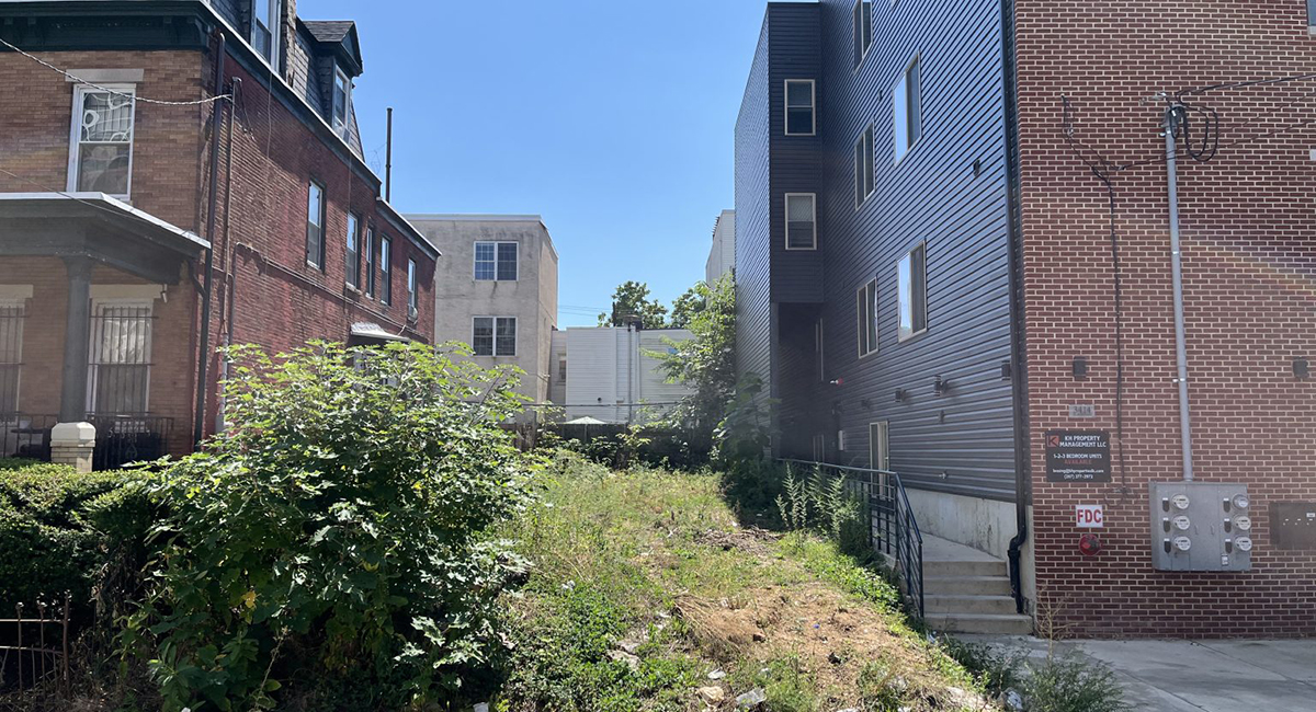 Vacant lot in between two tenement houses