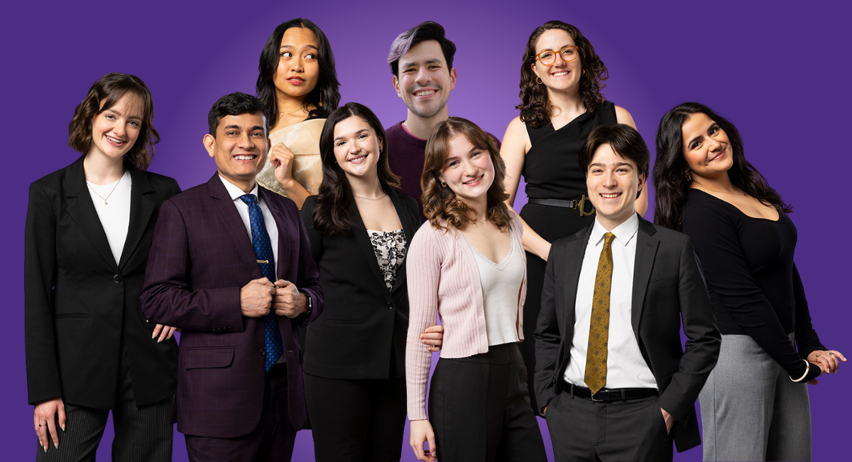 Nine people stand and smile against purple background