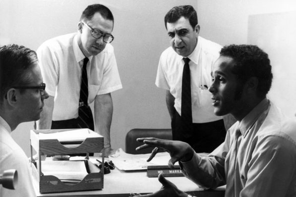 Dr. Richard A. Smith, founder of MEDEX Northwest, conversing around a table with colleagues