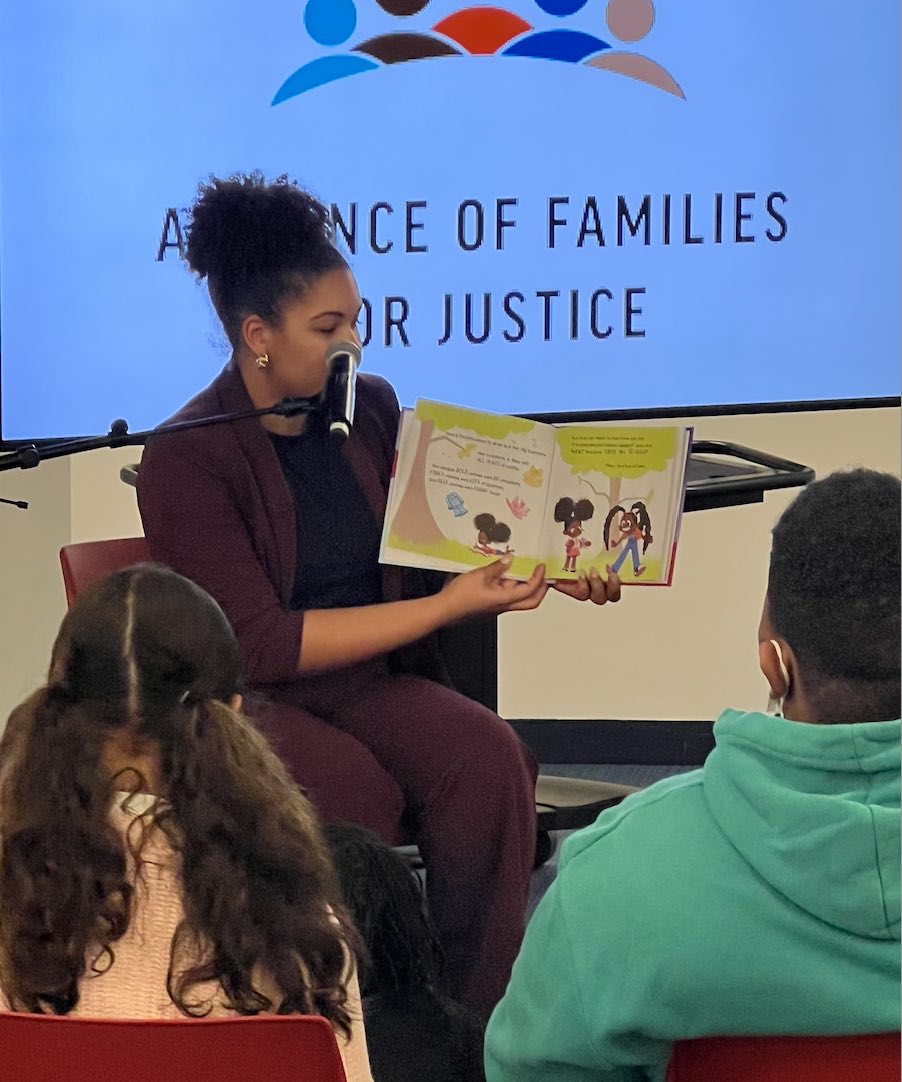 Dias reading at the Alliance of Families for Justice