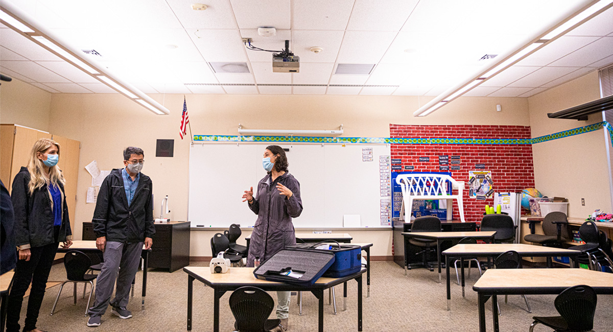 DEOHS Assistant Professor Elena Austin (right) discusses air sampling methods with State Rep. Tina Orwall (left) and former SeaTac Deputy Mayor Peter Kwon (center) during a visit to highline public schools in 2020.