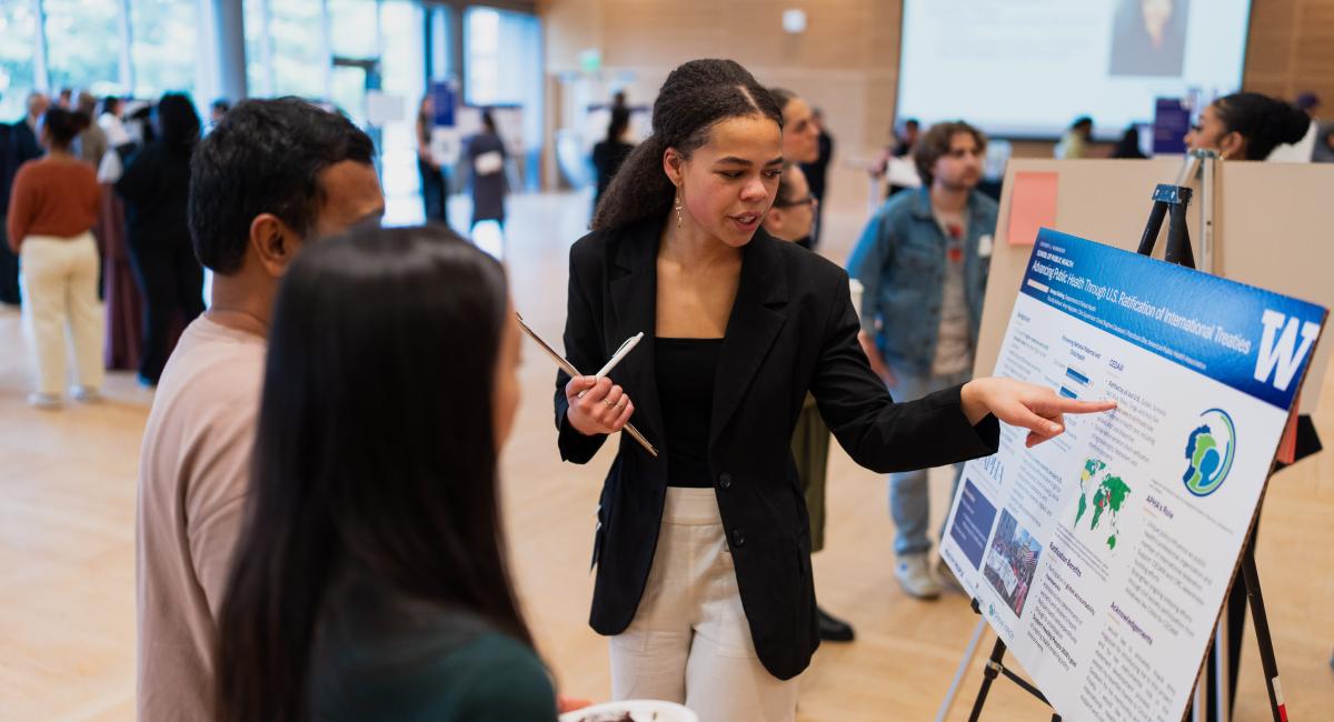 MPH student presenting poster at the symposium