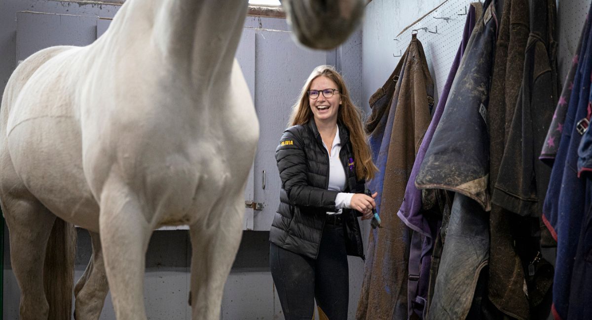 Olivia Brandon in horse stable, Photo by Mark Stone