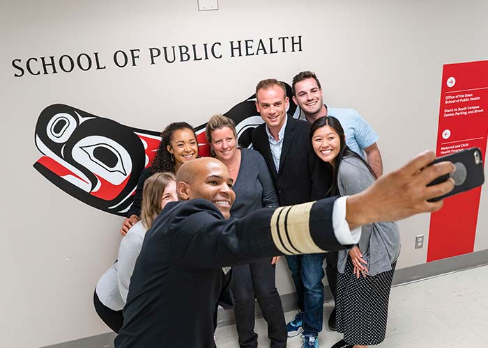 Jerome Adams selfie with students in front of SPH Soul Catcher