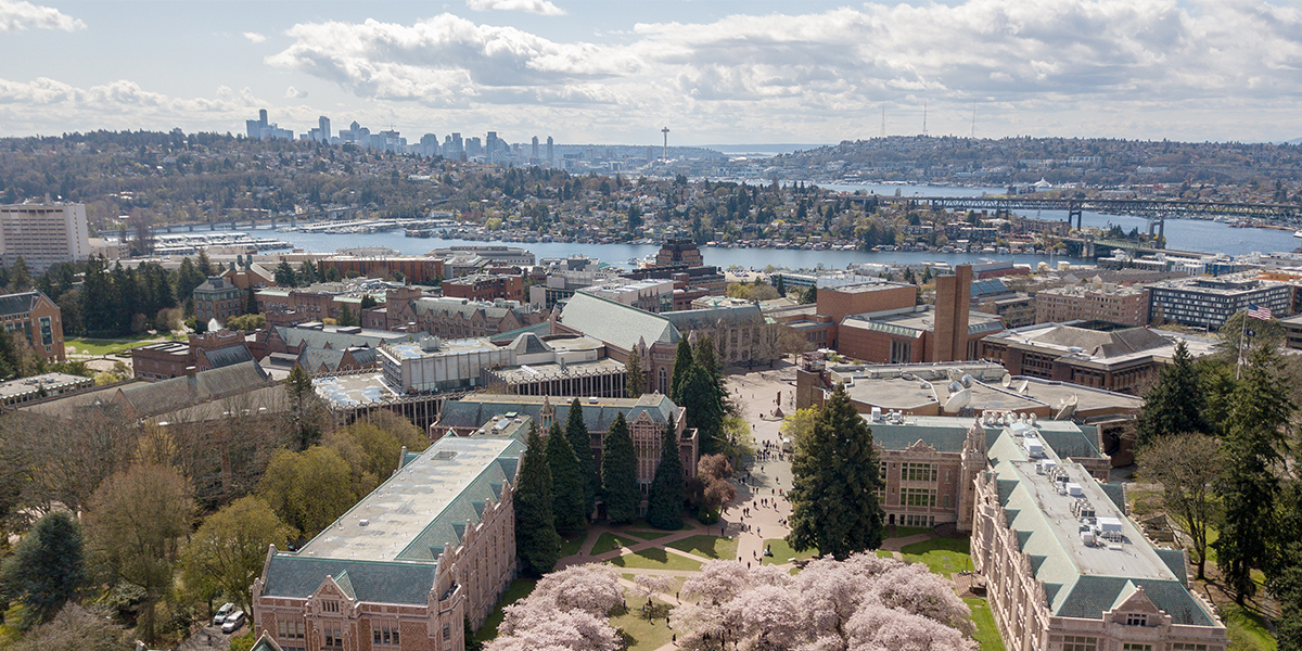 aerial shot of UW facing south to downtown Seattle with cherry blossoms in view