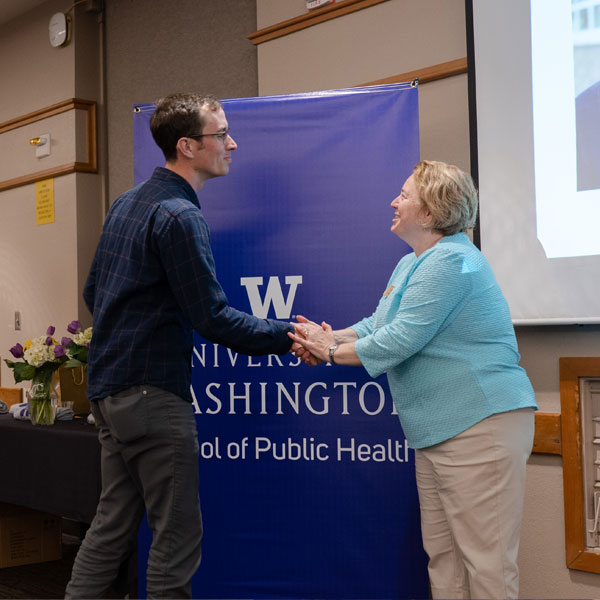 Kemp receives the 2019 PhD Omenn Award from Dean Hilary Godwin.