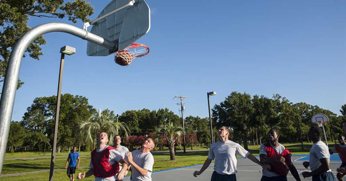Men playing basketball in a public park