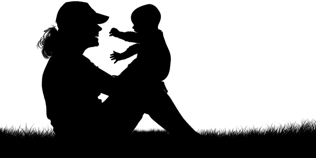 The silhouette of a mother holding her child.