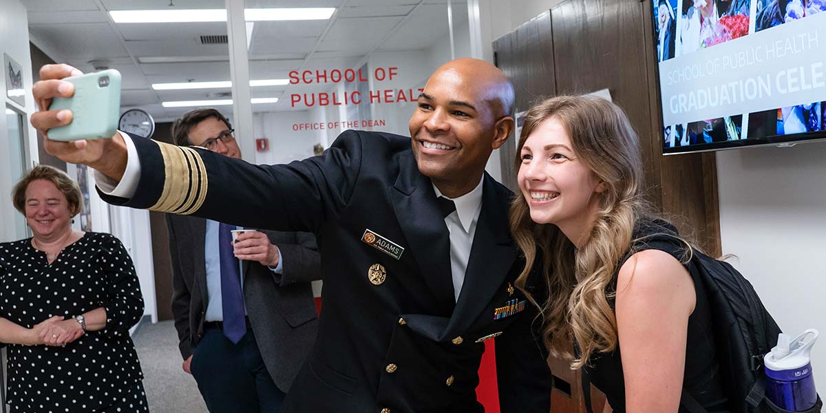U.S. Surgeon General Jerome Adams takes a selfie with MPH student Brandie Bockwoldt.