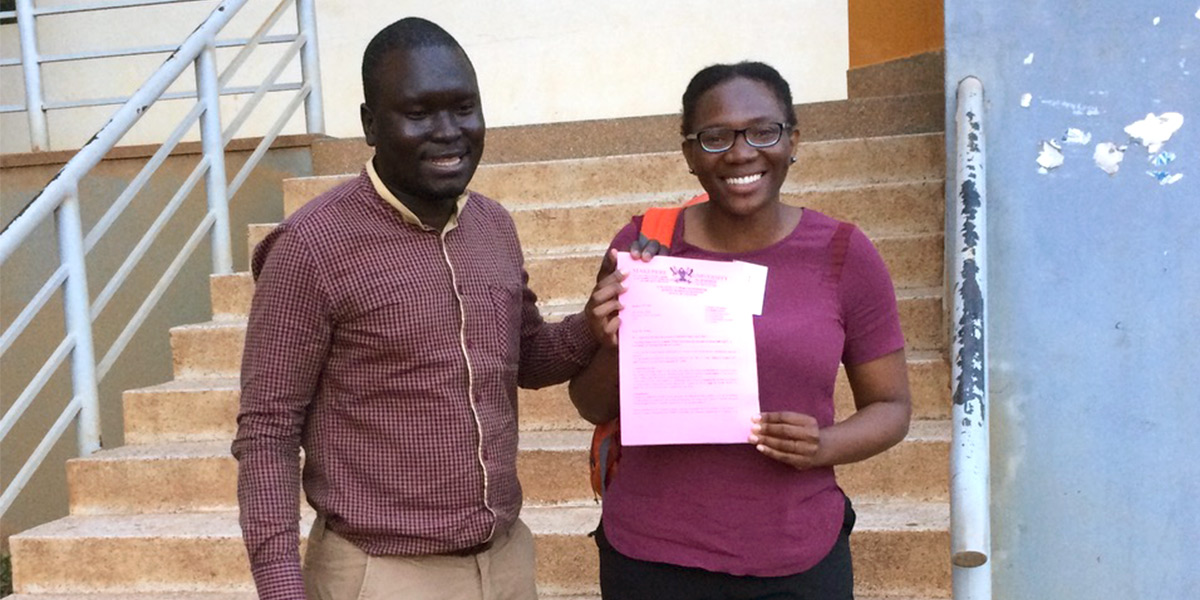 Aisha Abedi with co-author Dominic Ogwal holding their Uganda IRB approval certification letter