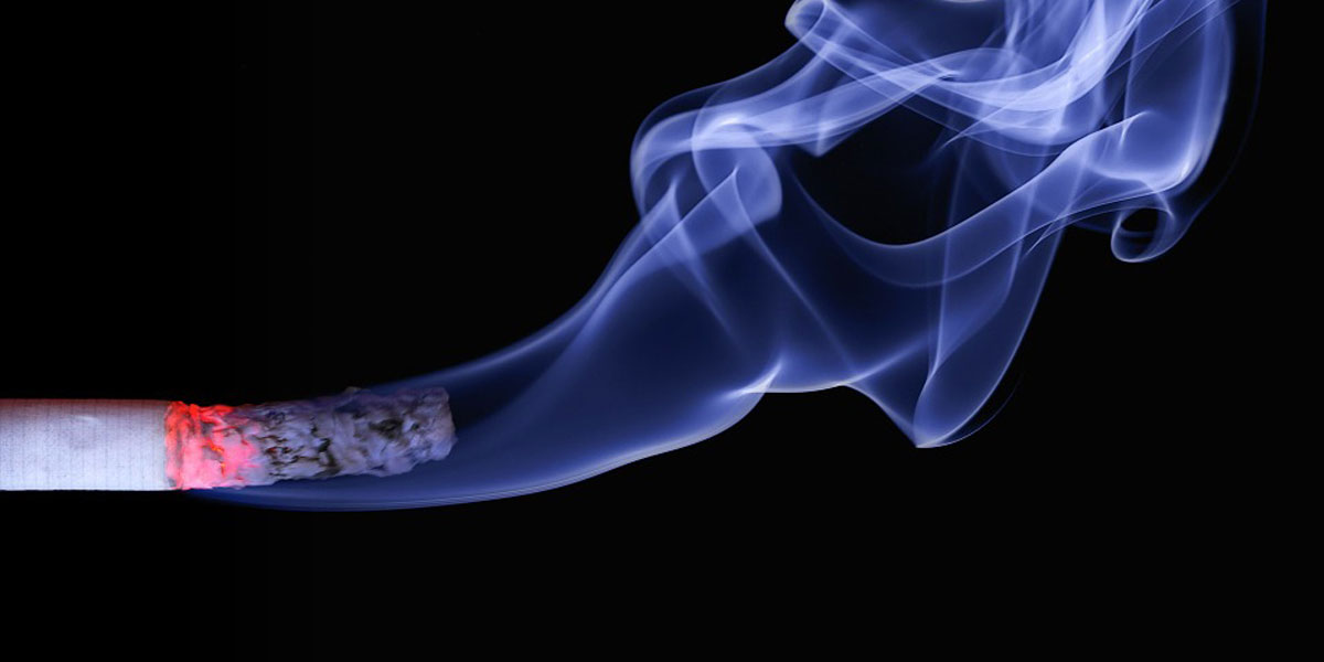 A burning cigarette with the formation of smoke