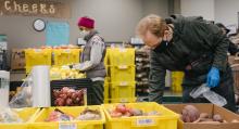 Volunteers prepare food for delivery to homes of people in need at the University District Food Bank in Seattle, Washington on Dec. 16, 2020.