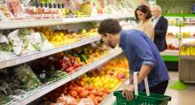 People shop for groceries in produce aisle