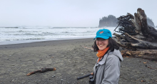 Cecilia Martindale stands on a cloudy ocean beach