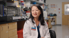 Helen Chu sits in a lab