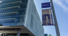 Glass building with sign that says "be boundless"