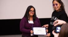 Anjulie Ganti smiles while holding award