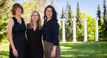 Three faculty stand together outside with UW's Silvan Grove pillars in background